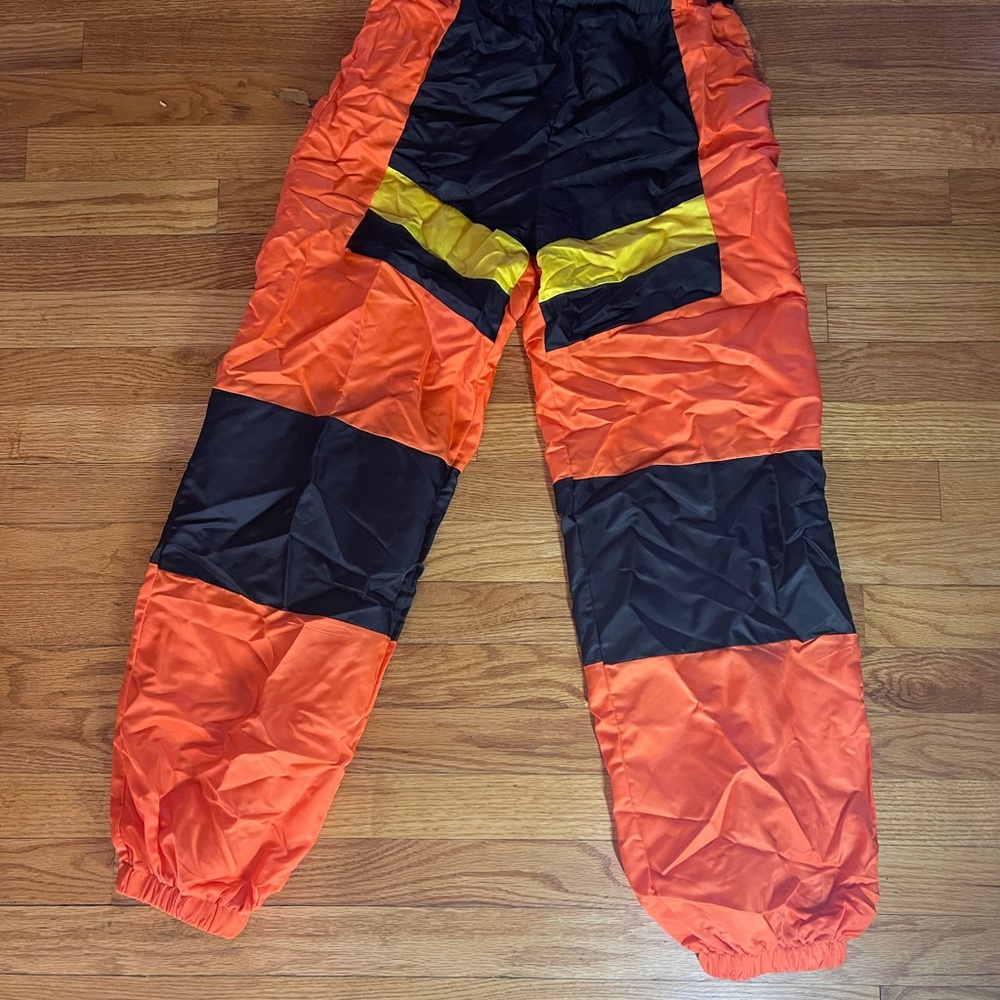 Fashion Nova orange, black and yellow windbreaker pants